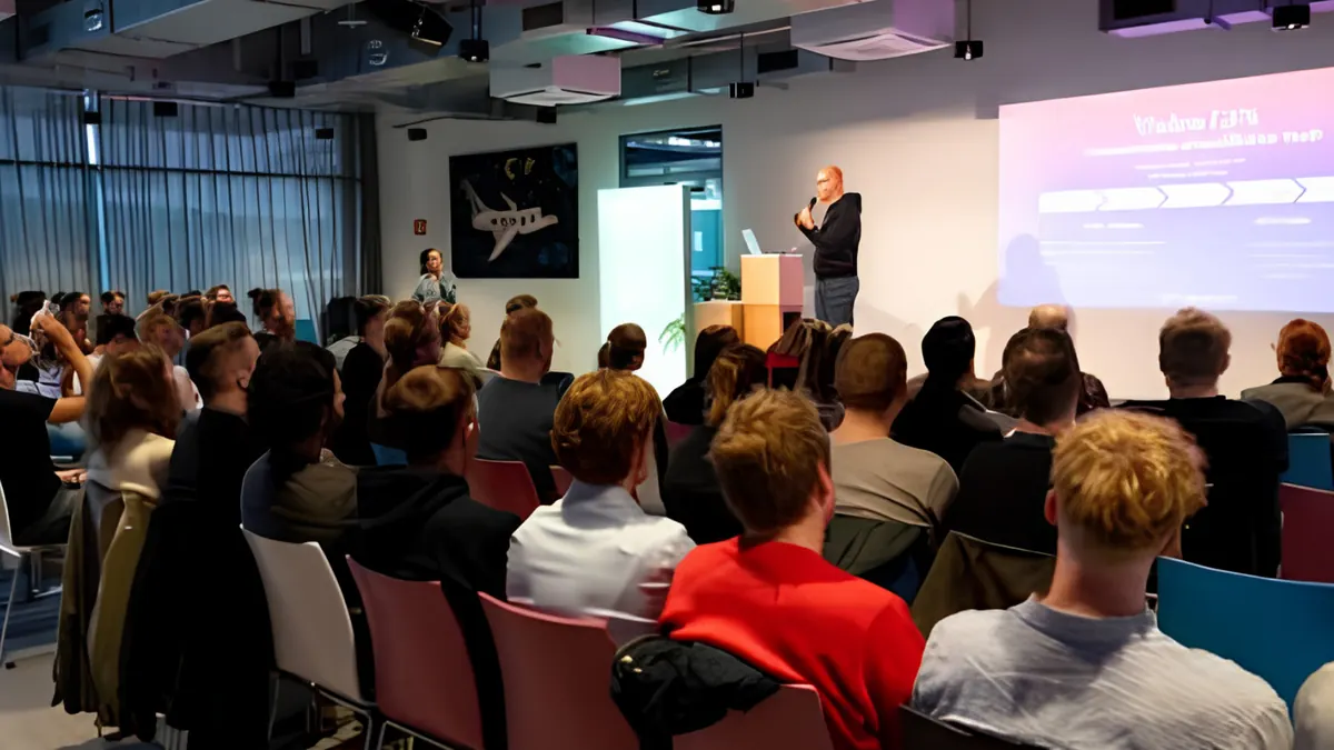 A founder pitching on stage to a seated audience